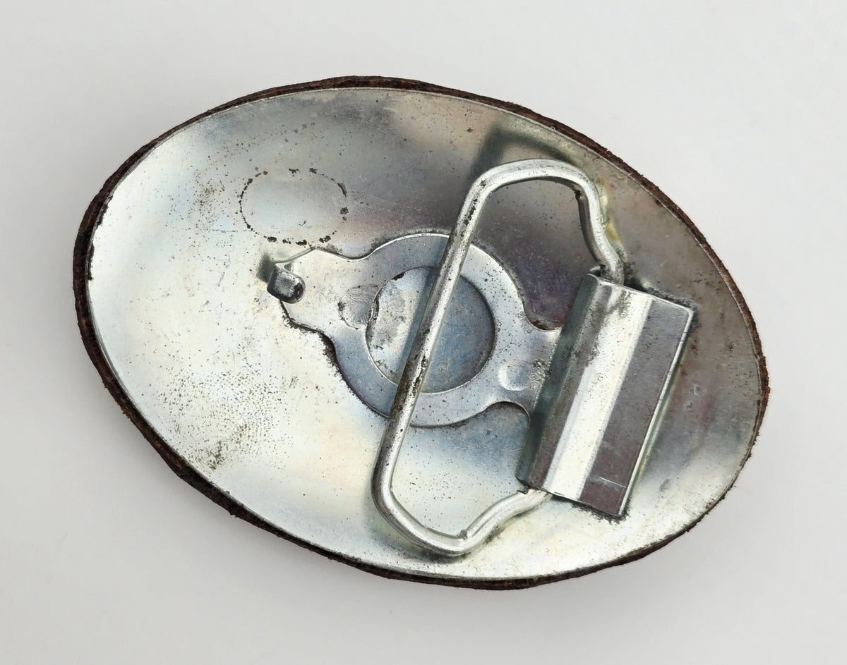 Back of the Hand Tooled Leather Vintage Belt Buckle — Oval Rust & Gold Pinwheel, showing the silver-tone metal belt buckle back and loop hardware.