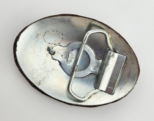 Back of the Hand Tooled Leather Vintage Belt Buckle — Oval Rust & Gold Pinwheel, showing the silver-tone metal belt buckle back and loop hardware.