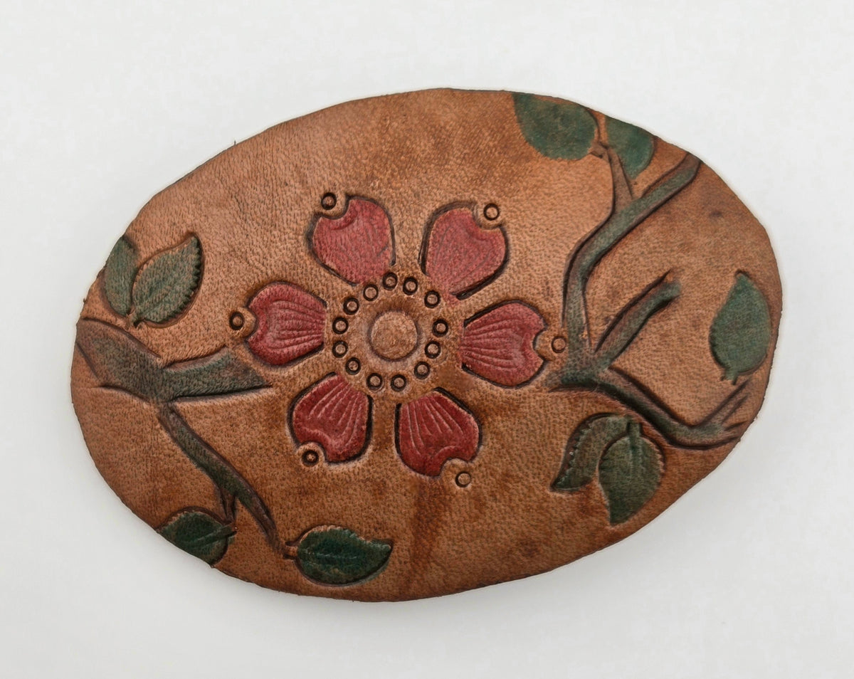 Front of the Hand Tooled Leather Vintage Belt Buckle — Oval Red Flower & Green Vine, showing an oval face with a central six-petal red flower on a winding green vine.