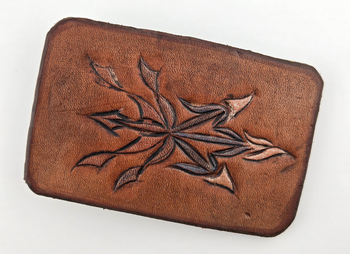 Front of the Hand Tooled Leather Vintage Belt Buckle — Pointed Leaf Star, showing a single pointed-leaf star flower carved in dark outline on a plain tan-brown face.