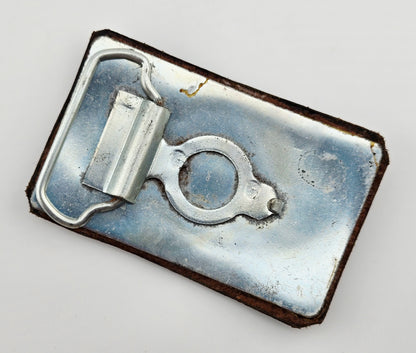 Back of the Hand Tooled Leather Vintage Belt Buckle — Snail with Spiral Shell, showing the silver-tone metal belt buckle back and loop hardware.