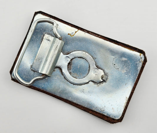 Back of the Hand Tooled Leather Vintage Belt Buckle — Snail with Spiral Shell, showing the silver-tone metal belt buckle back and loop hardware.